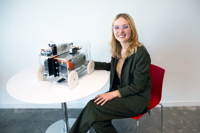 Harvard SEAS senior Maycee Wieczorek with her senior capstone project, a mechanical device for controlling potato harvests