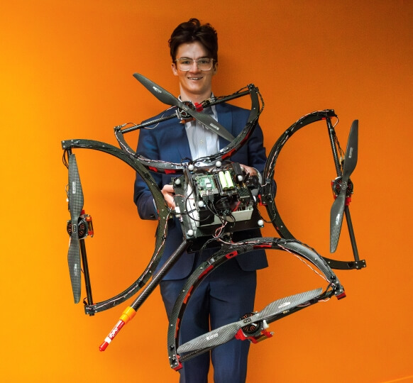 Harvard SEAS senior Lachlain Granahan holding a quadcopter drone