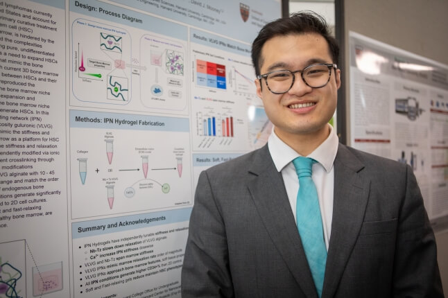 Harvard SEAS senior Andrew Lu in front of a poster of his capstone project on hematopoietic stem cells