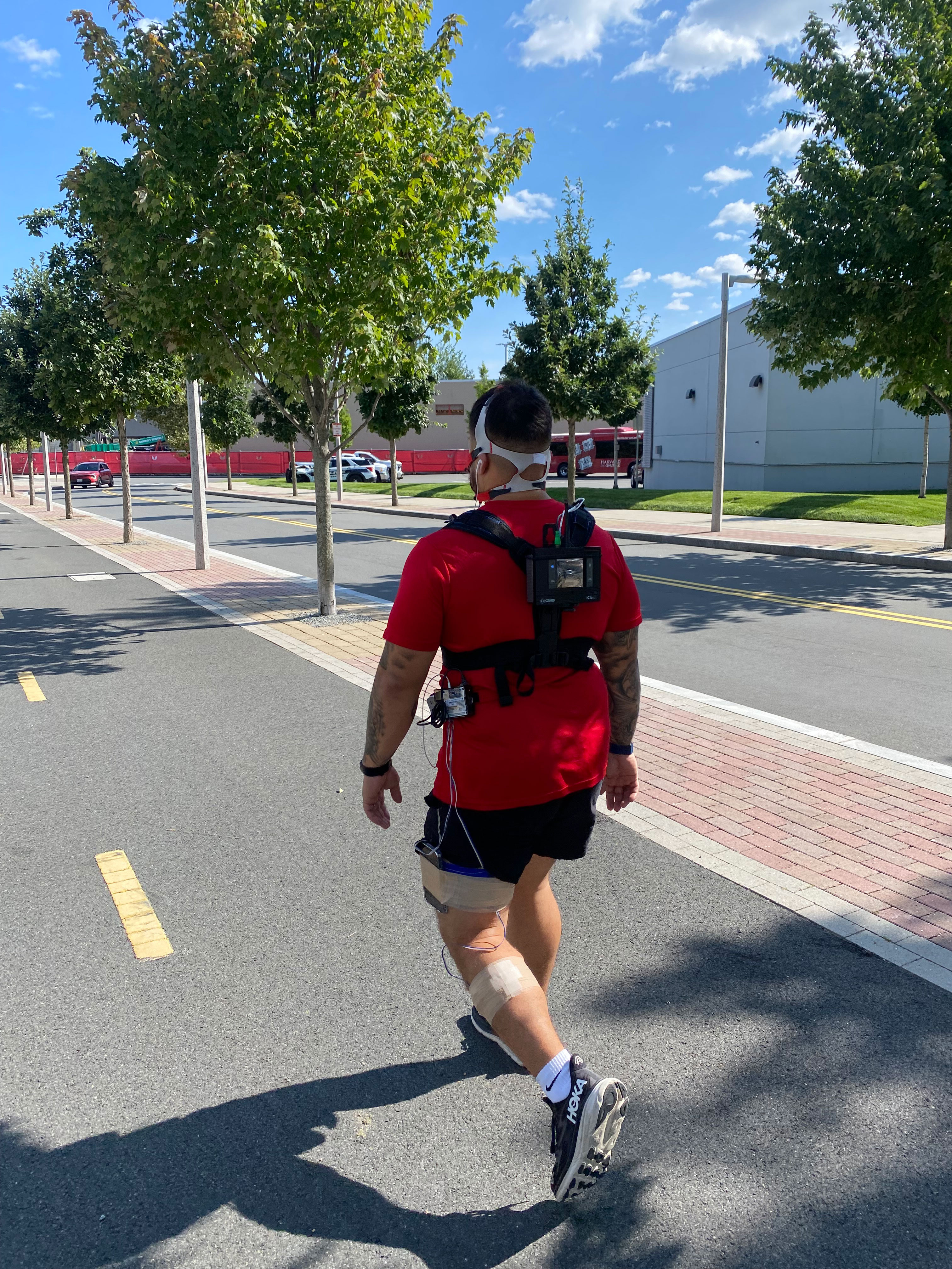 person walking while wearing fitness-tracking sensors
