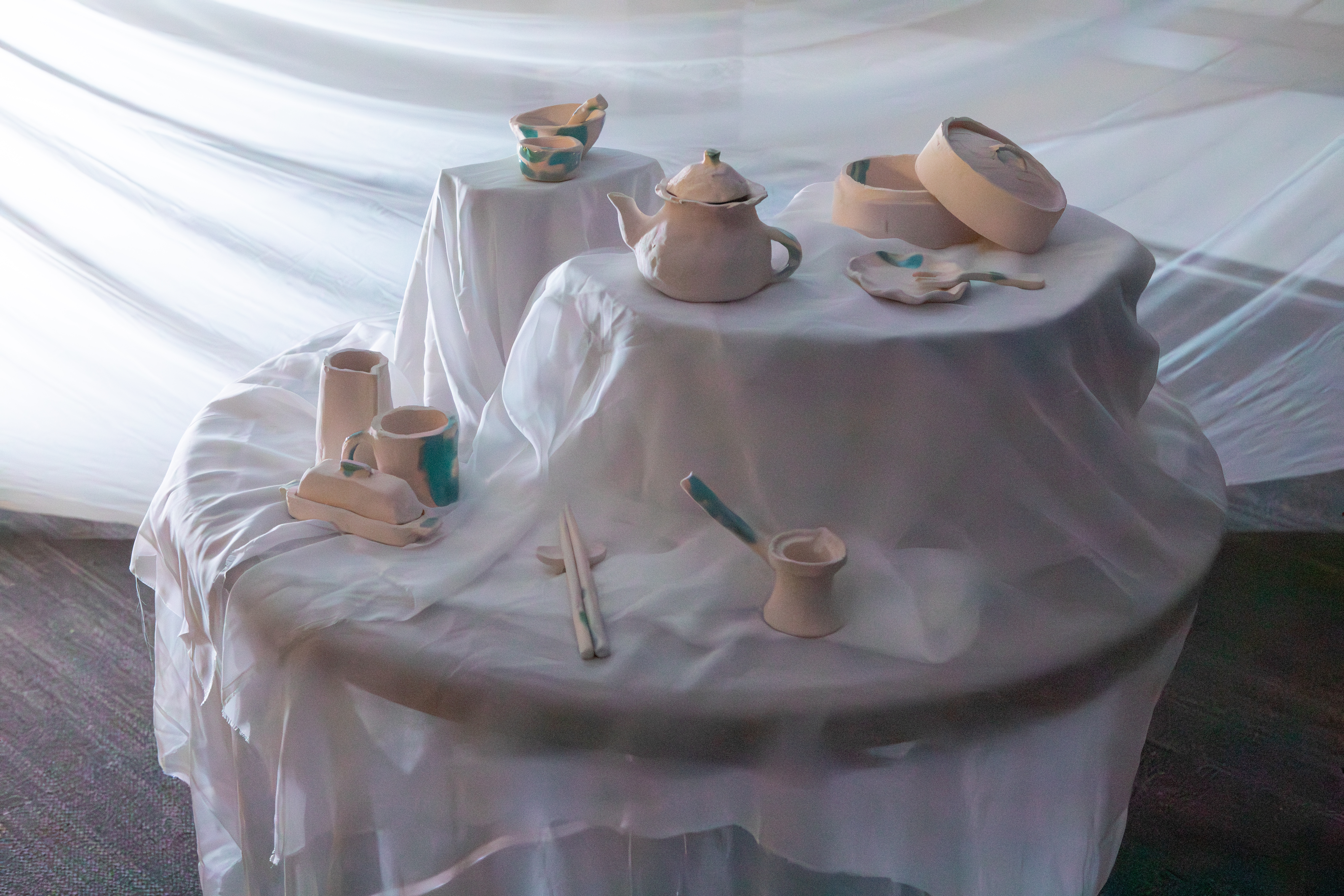 A collection of cermaic pieces designed to look like utensils and dining room implements