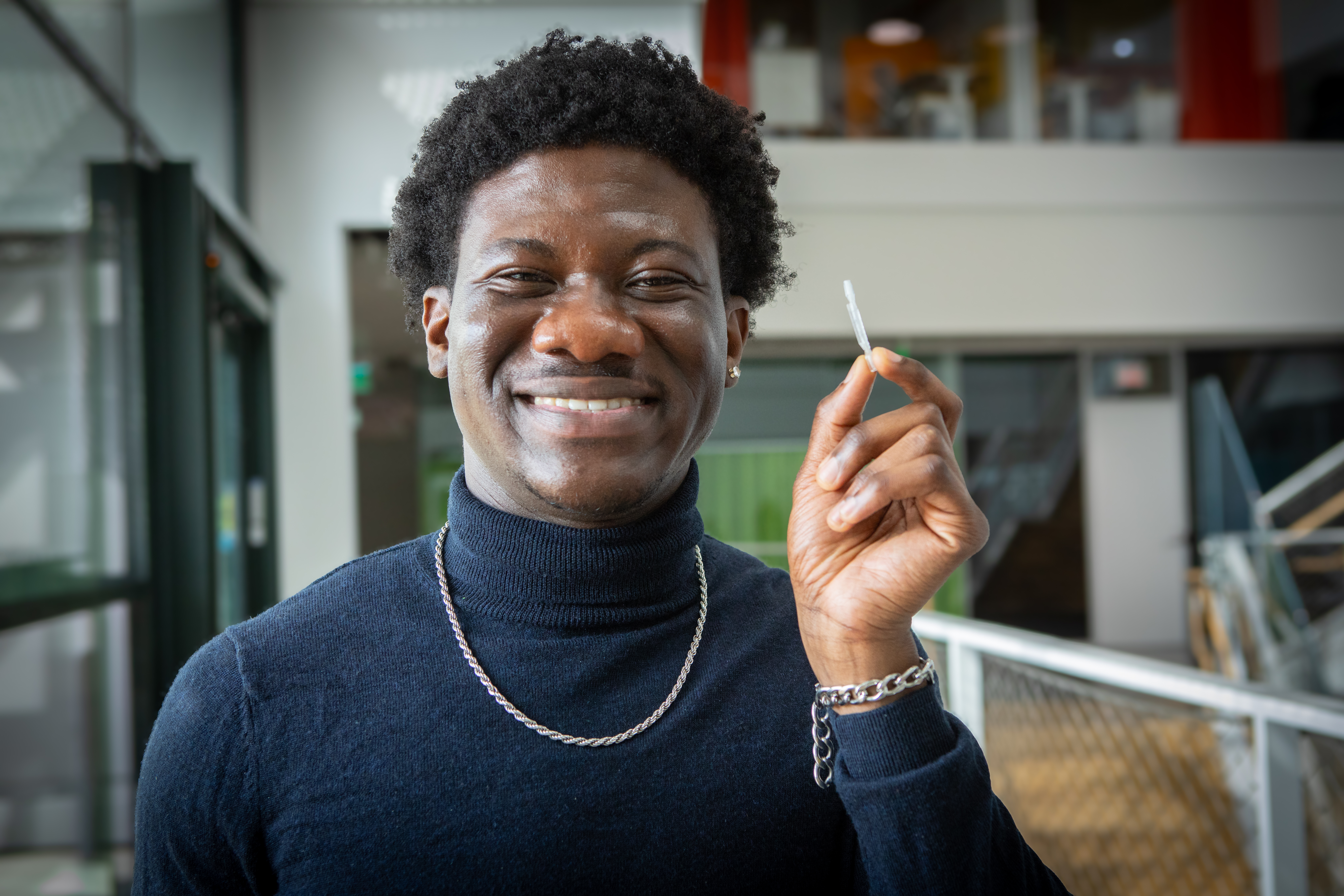 Harvard SEAS student Kow Simpson holding a small device