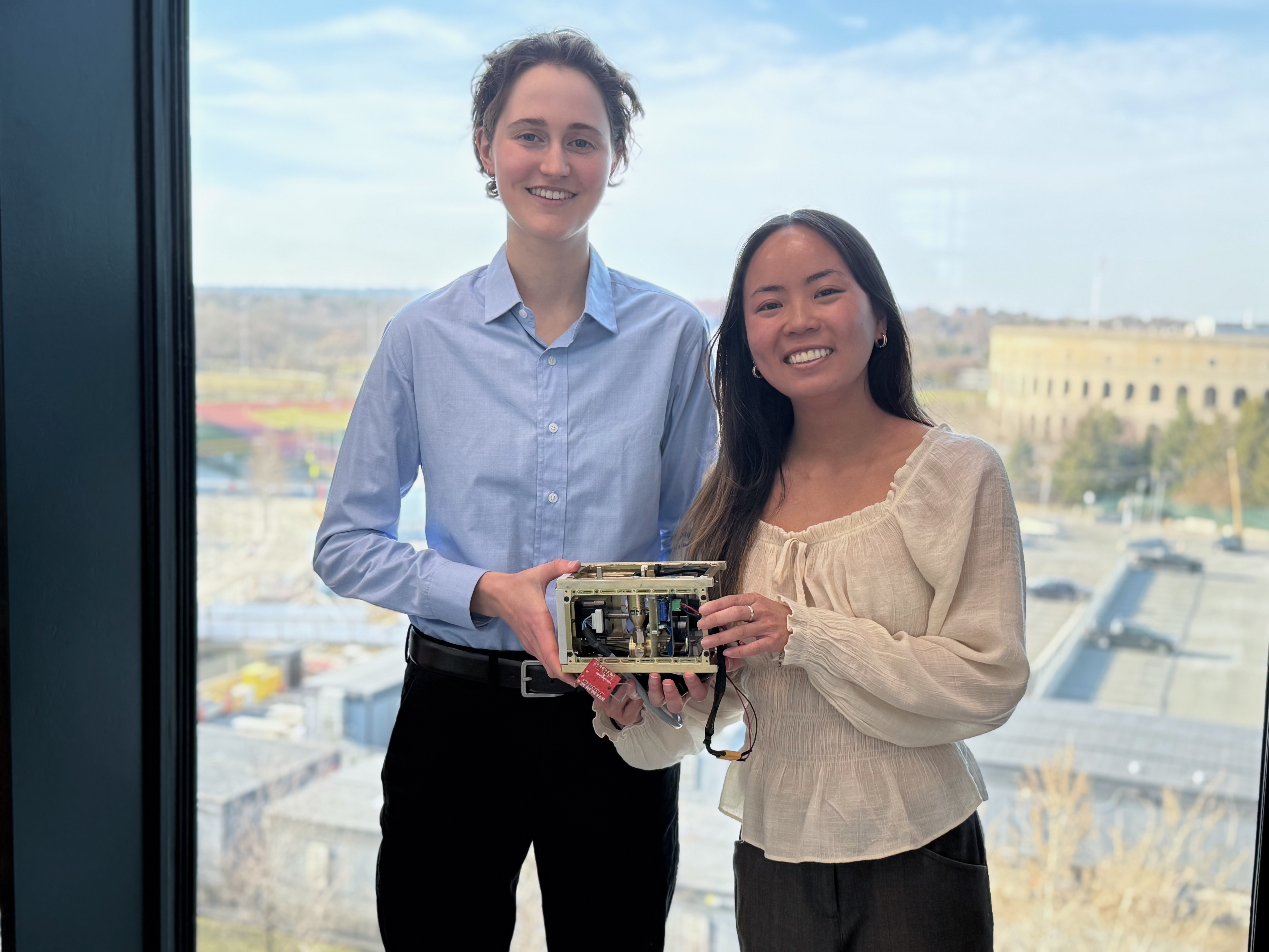 Harvard SEAS students Isabel Laguarda and Jennifer Nguyen holding their senior capstone project