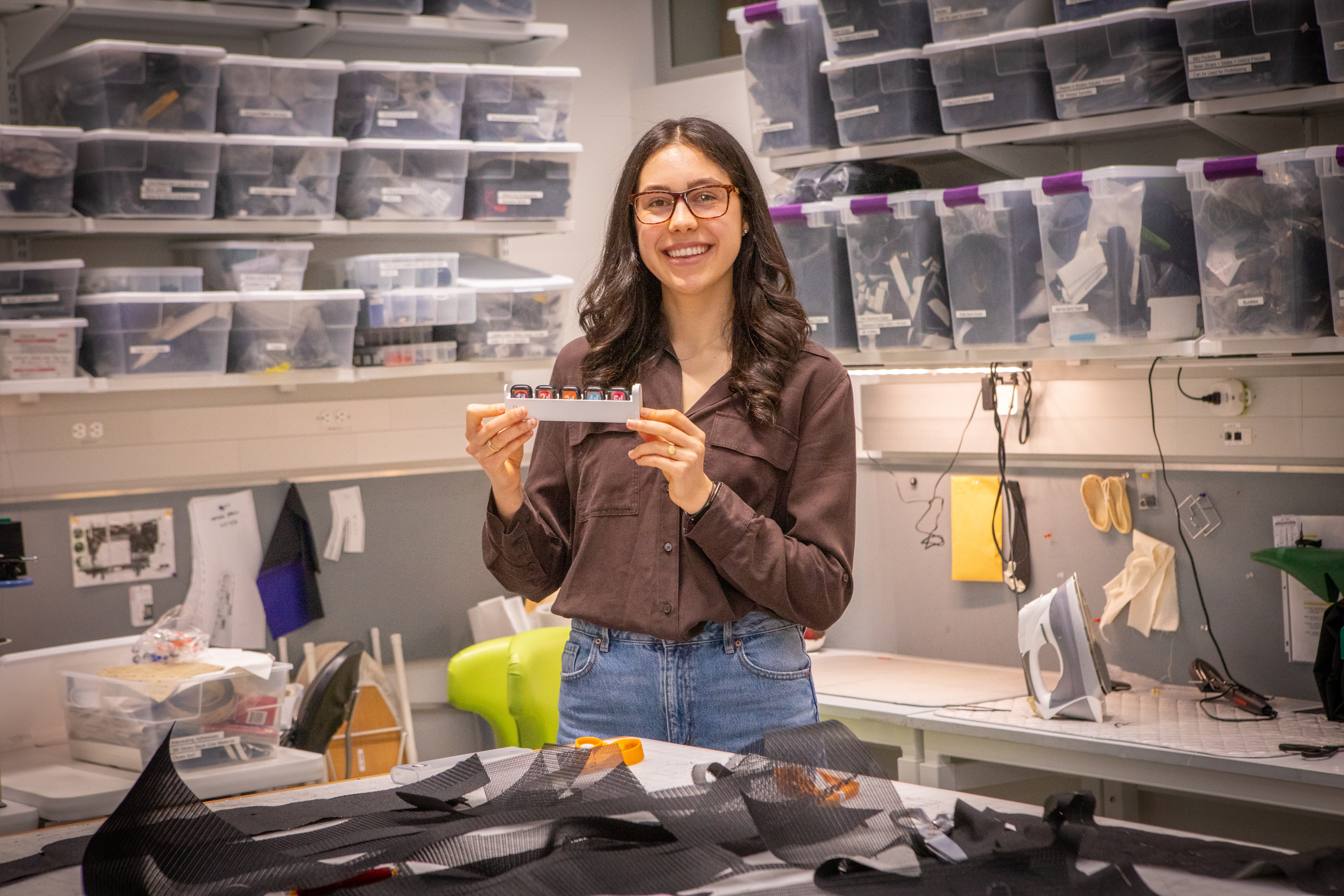 Harvard SEAS student Alissia Di Maria holding a tray of smart watches