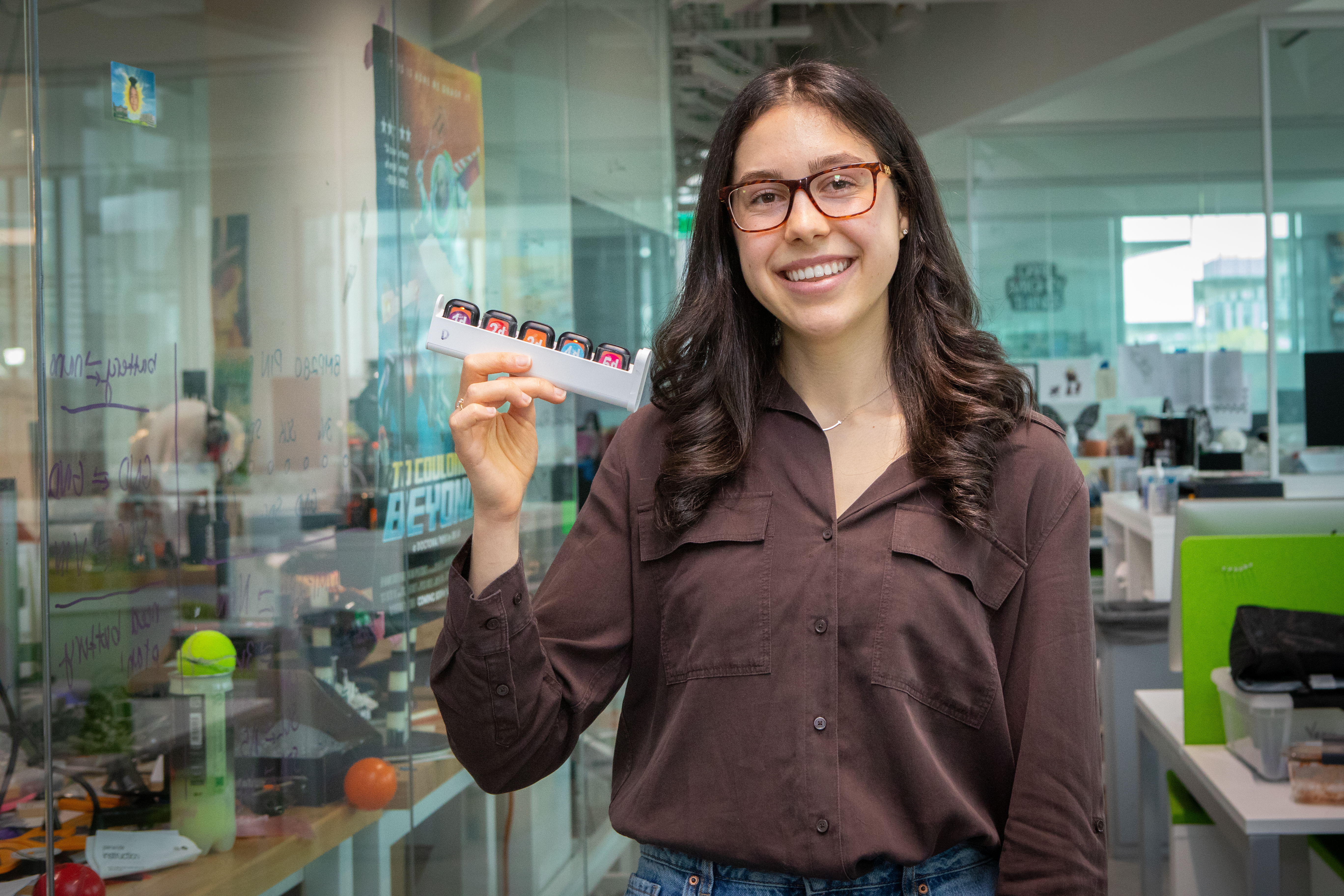 Harvard SEAS student Alissia Di Maria holding a tray of smart watches