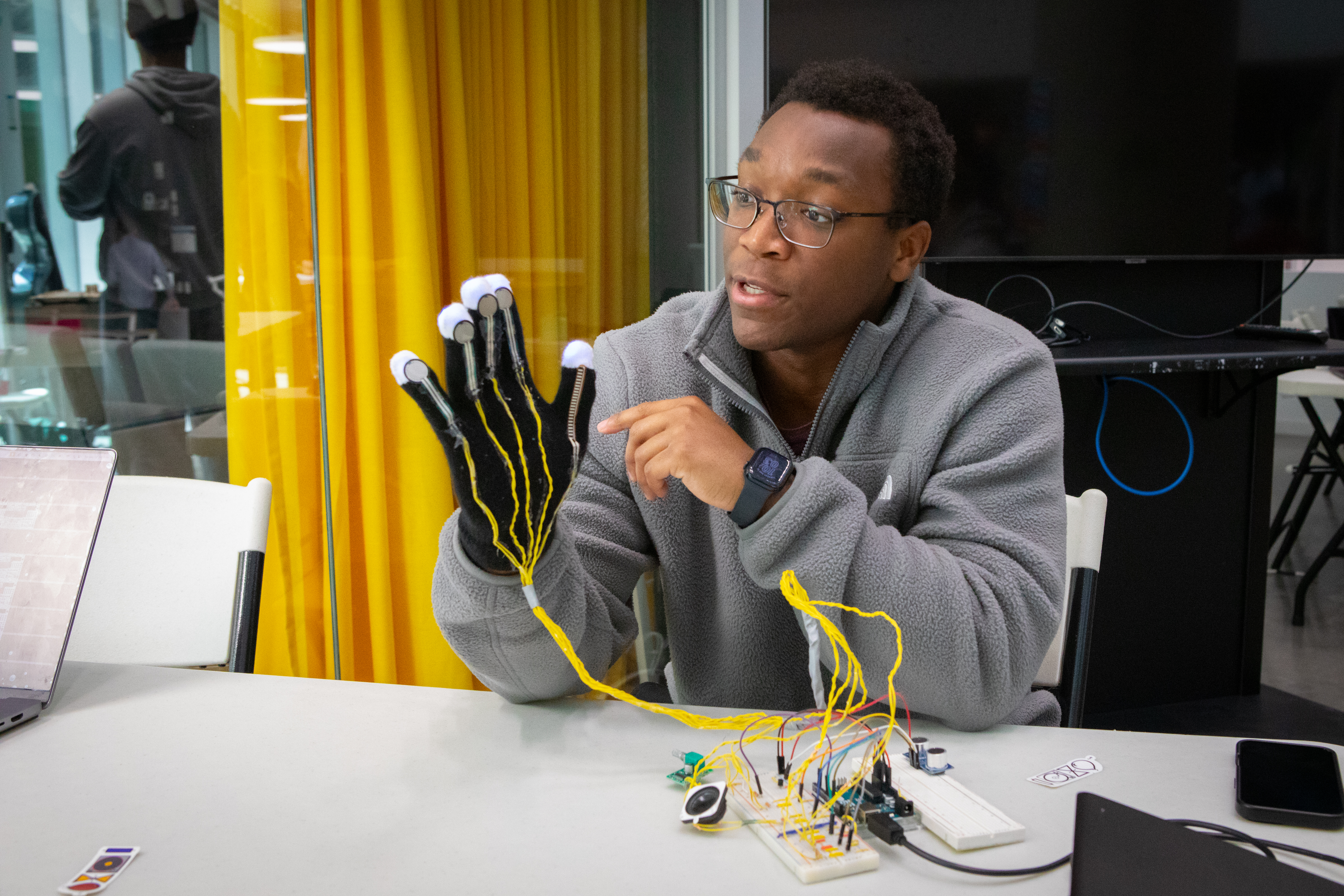 Harvard student Tinaye Ngorima wearing a glove that works like a musical instrument