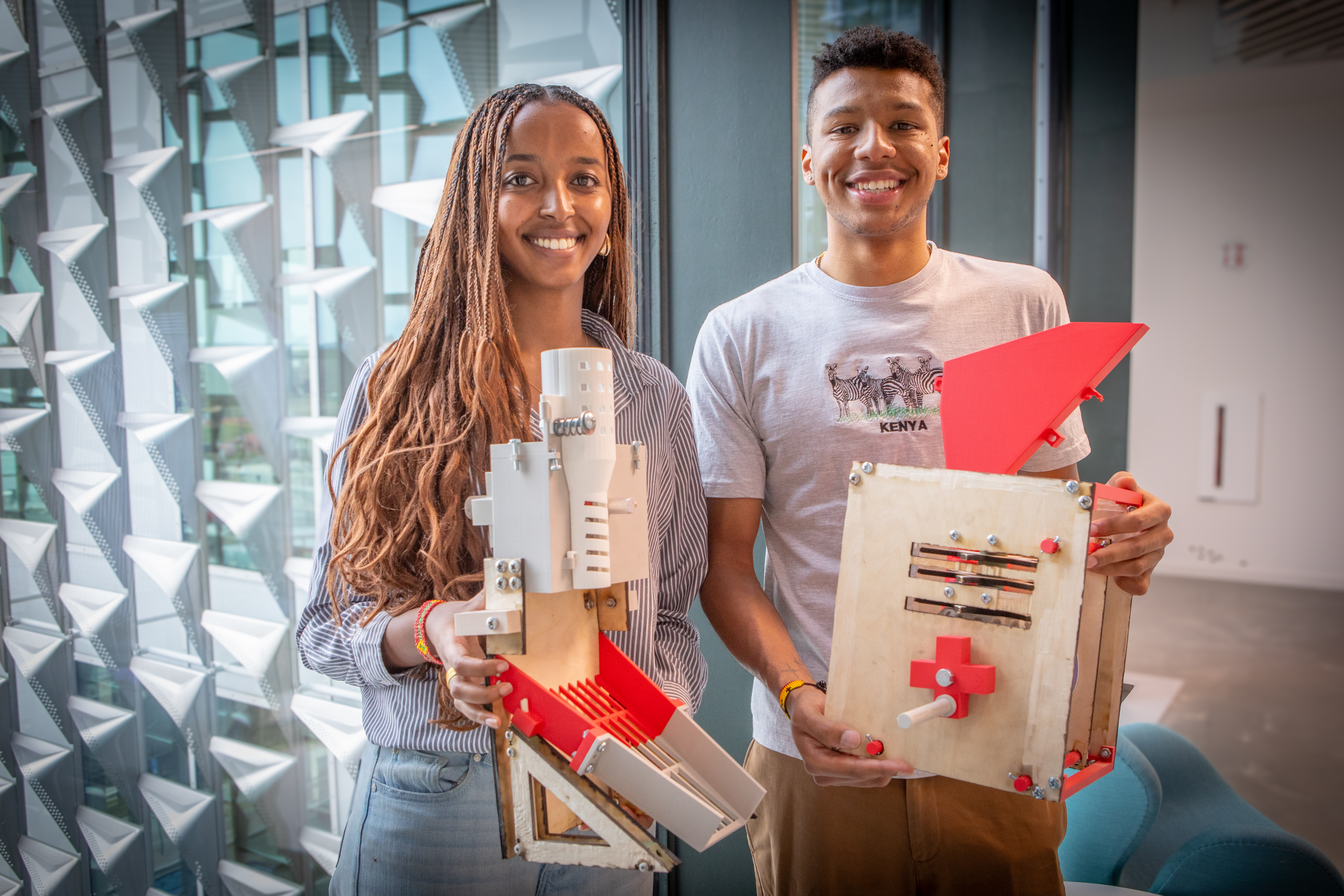 Harvard SEAS students Kulani Temesgen and Ayande Joseph holding devises for shelling maize