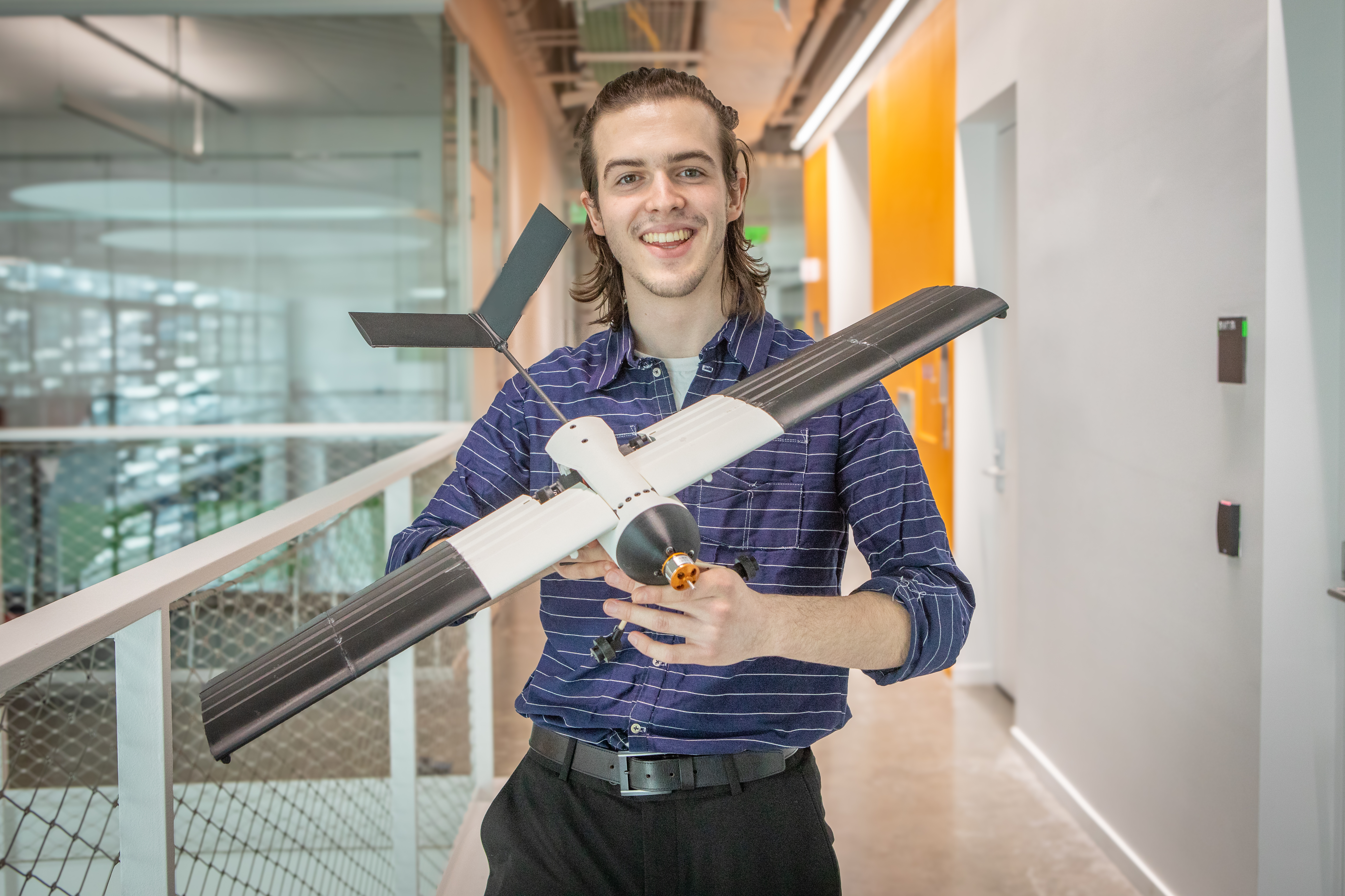 Harvard SEAS student Finn Seyffer holding a model aircraft