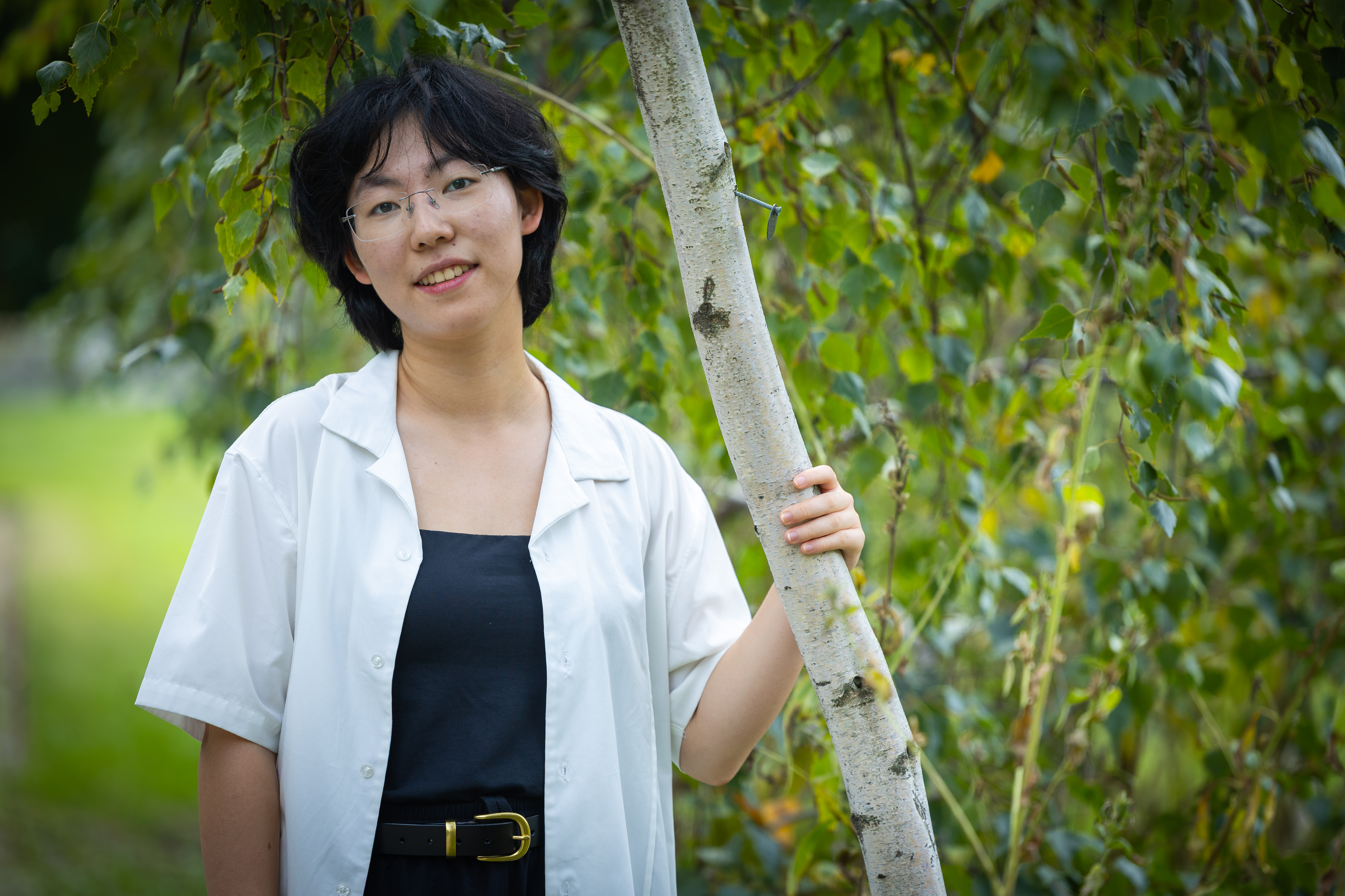 Harvard SEAS student Luna Yin standing next to a tree