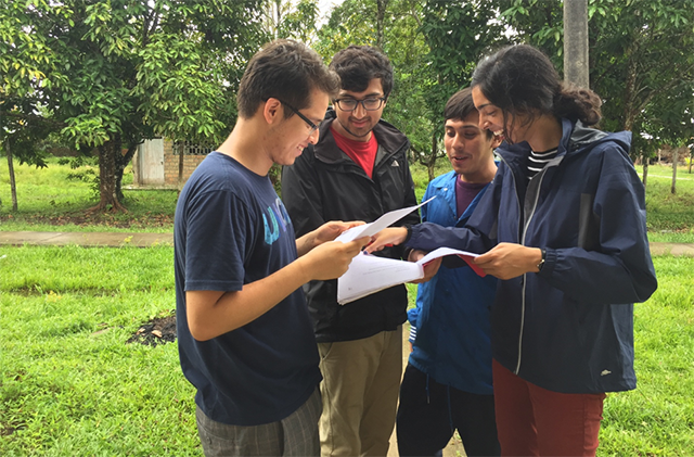 The UniDx team discusses details during the pilot study in the Manacamiri Village in the Peruvian Amazon. (Photo courtesy of Neil Davey) 