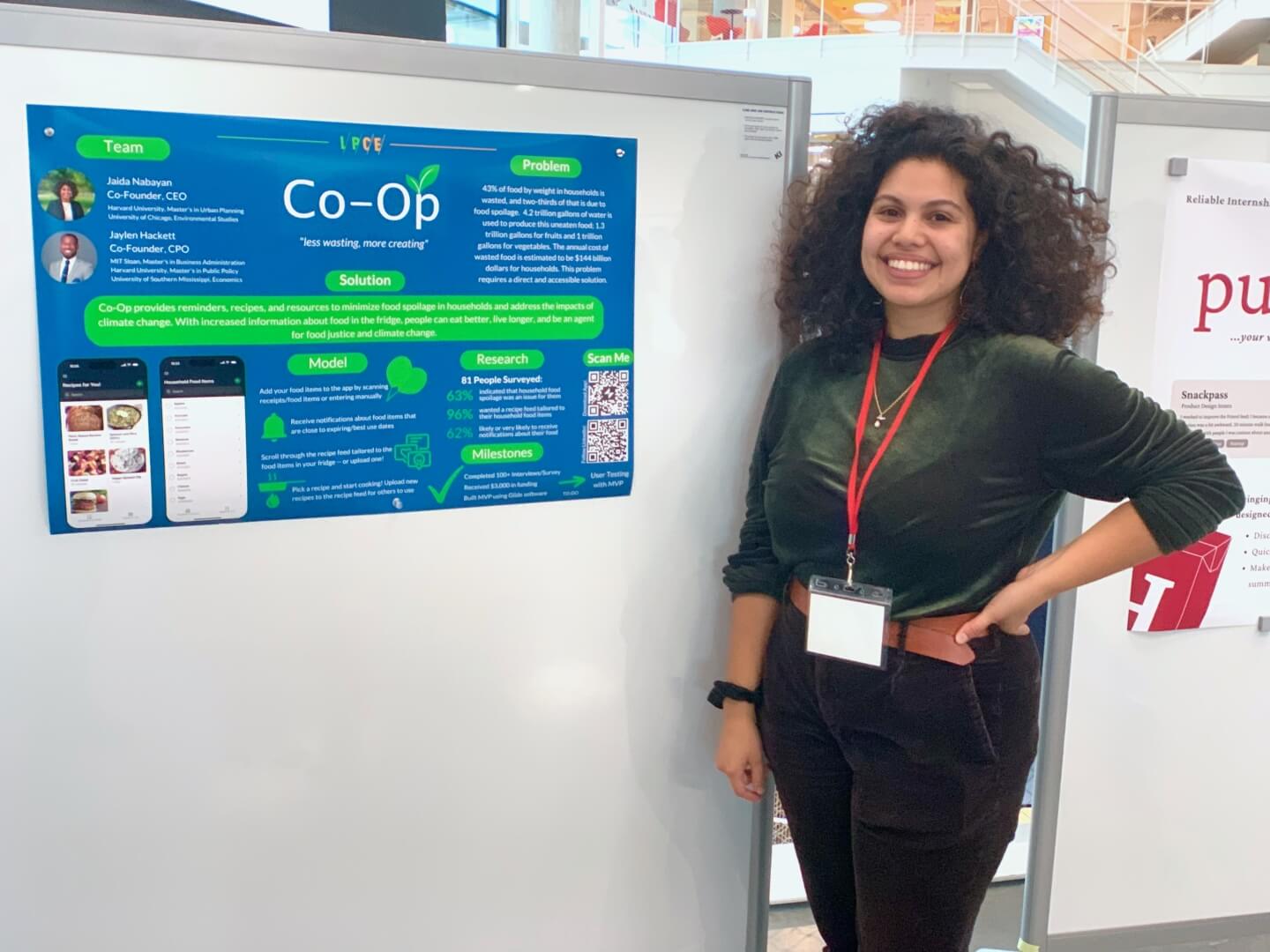 Jaida Nabayan with a poster for the start-up "Co-Op"