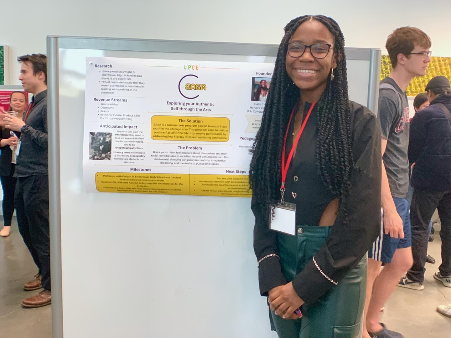 Halle Clottey with a poster for the start-up “EASA (Exploring your Authentic Self through the Arts)”