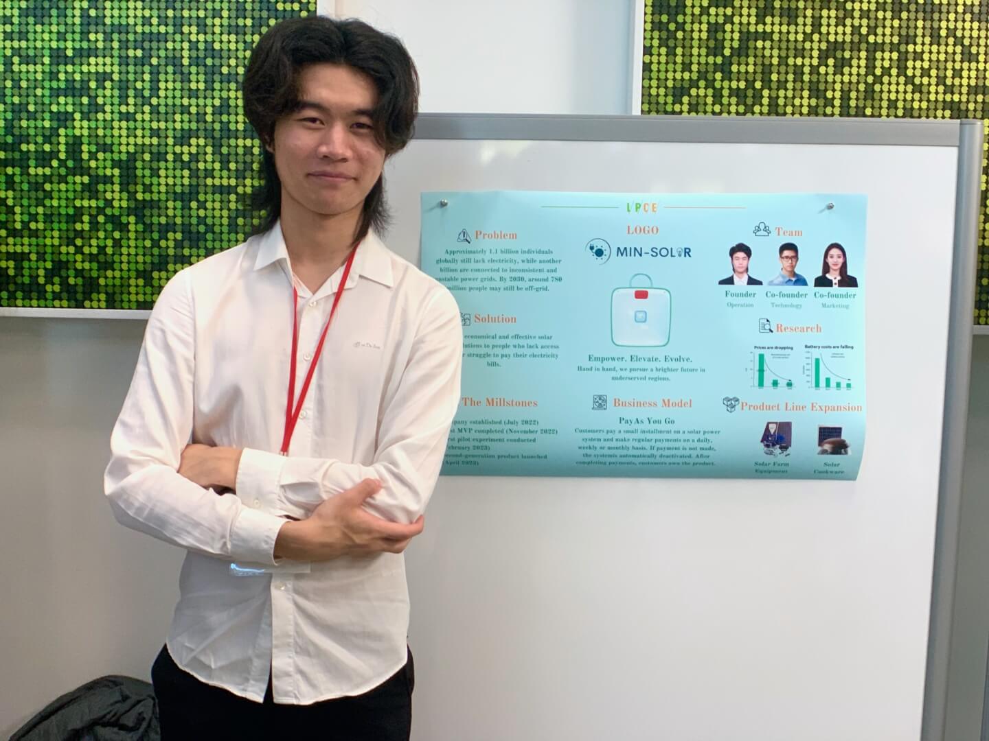 Andrew Sun with a poster for the start-up "Min-Solar"