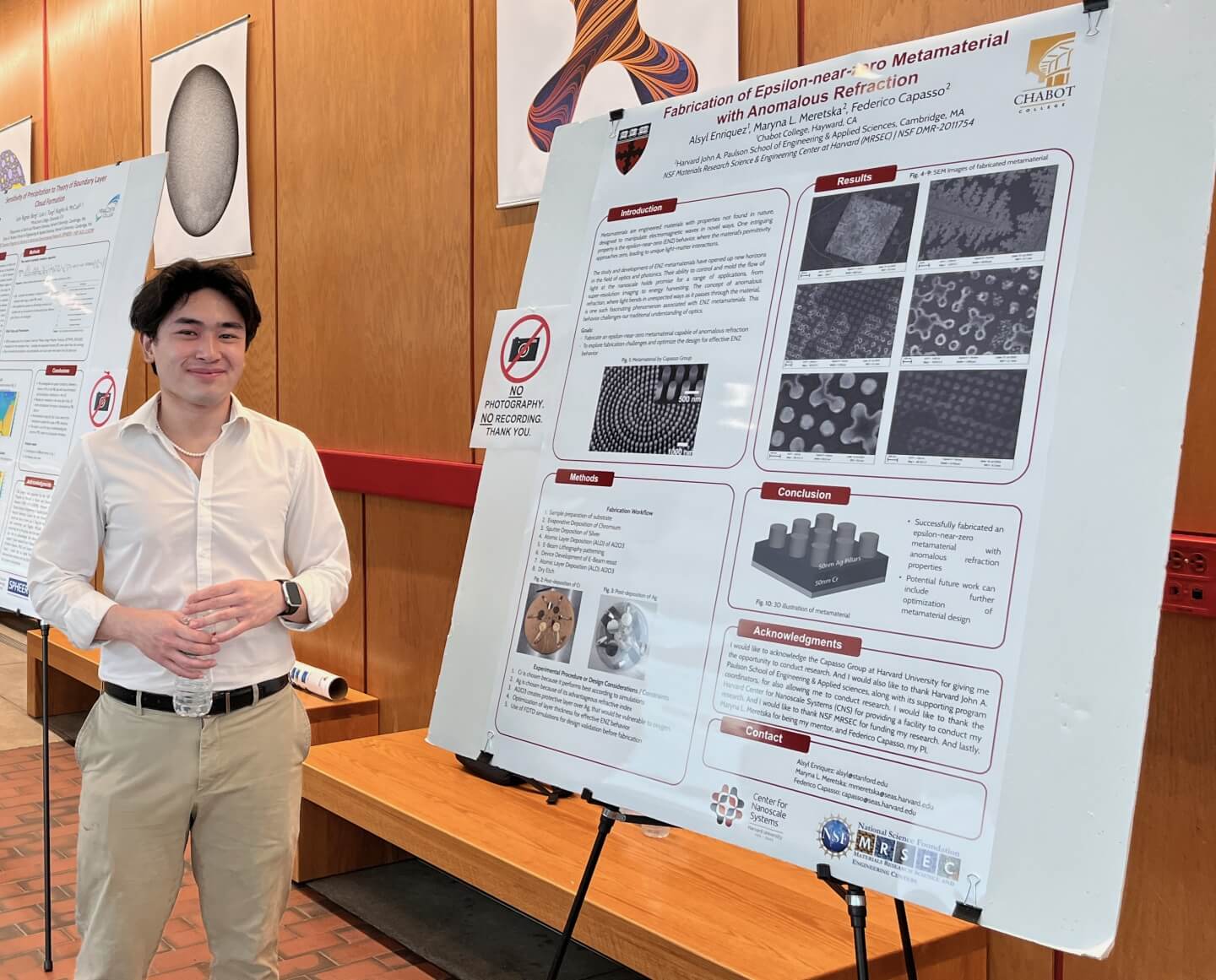 Alsyl Enriquez, a rising junior electrical engineering and computer science student at Cabot College, with his REU research poster