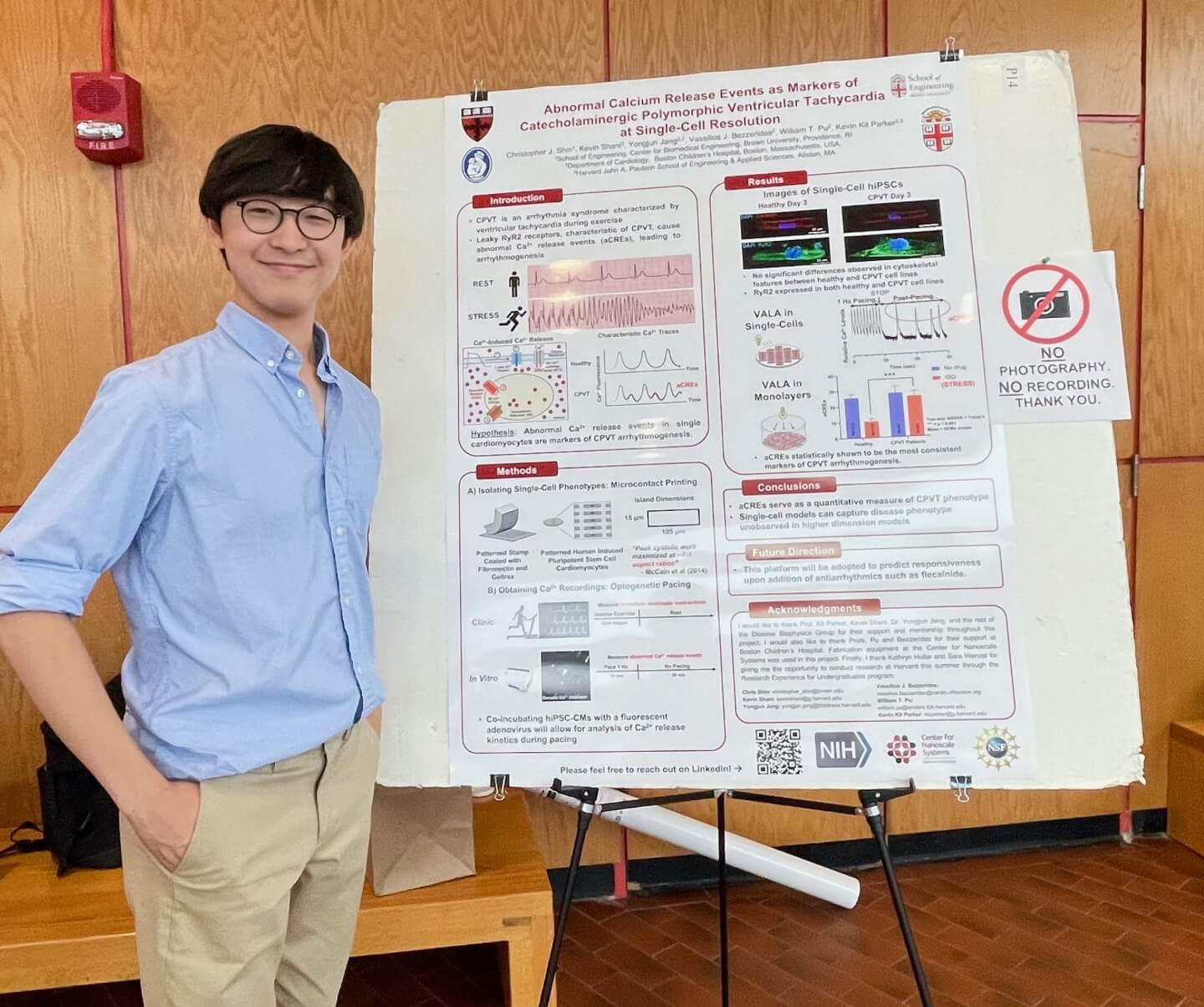 Christopher Shin, a rising senior biomedical engineering major at Brown University, with his REU research poster