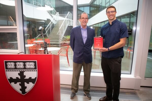 Dean Frank Doyle with Ethan Seder, who is holding a plaque 