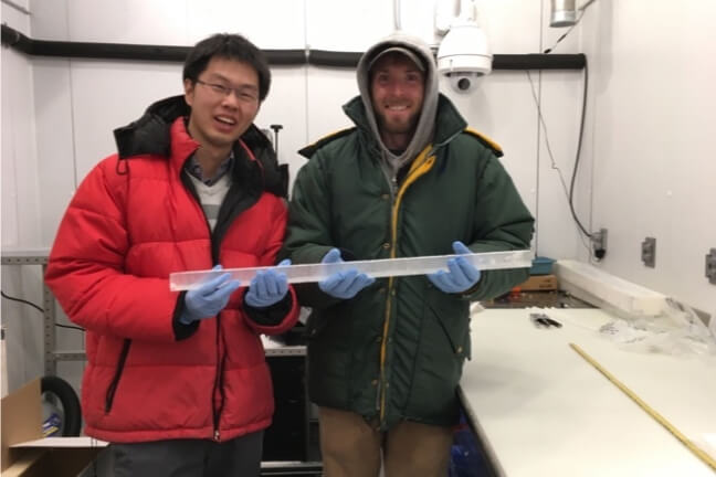 two people holding ice core