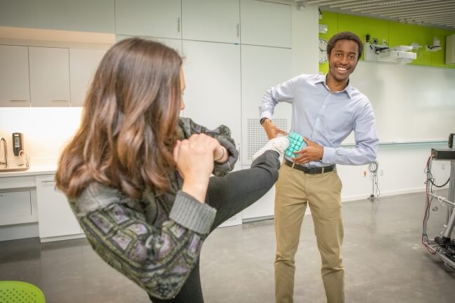 Roundhouse Technologies members Kade Kelsch, left, and Olisaneme Okonkwo demonstrate their optical tunnel sensor