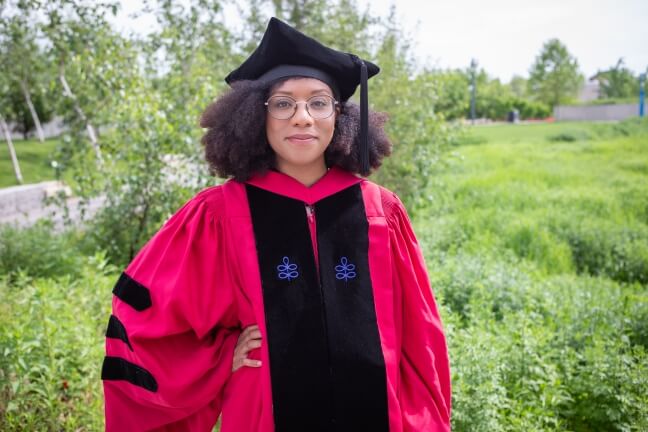 Harvard SEAS student Jamelle Watson-Daniels wearing her crimson regalia