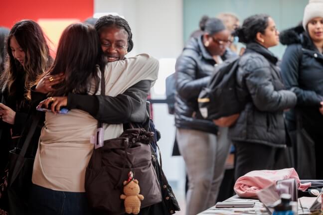 Two female students embracing