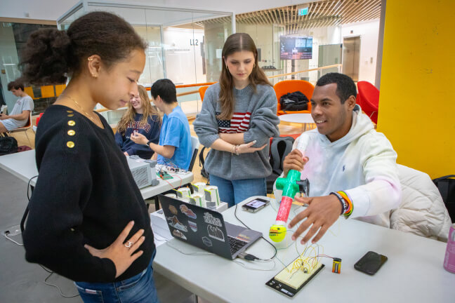 Harvard students Mekhi Moore and Arba Kamberi with an electronic musical instrument inspired by the Japanese otamatone