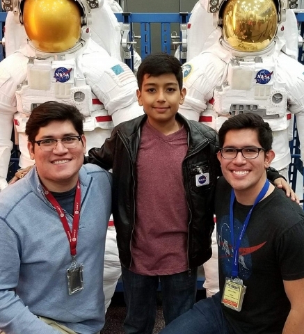 Juan Carlos López with his brother and nephew exploring NASA exhibits