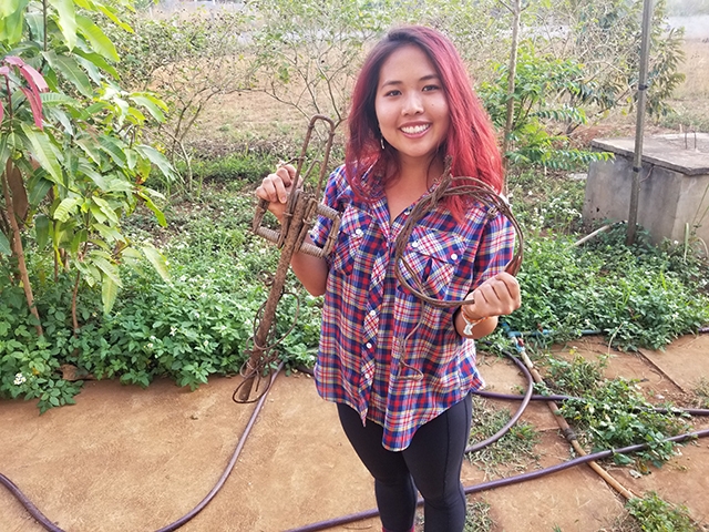 Lily Xu holds a wildlife trap and snare