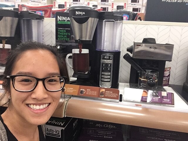 Stephanie Manivanh poses with a Ninja coffee maker