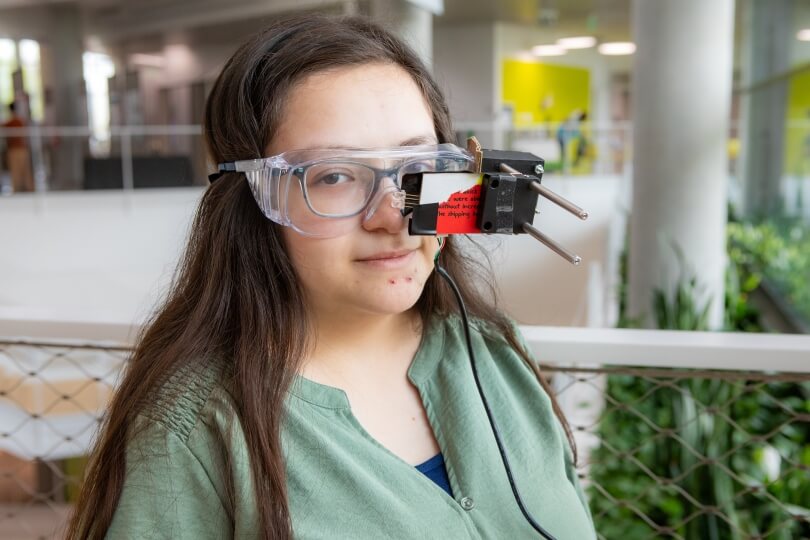 Harvard SEAS senior Anna Ramos wearing safety goggles adapted to act as a video game controller