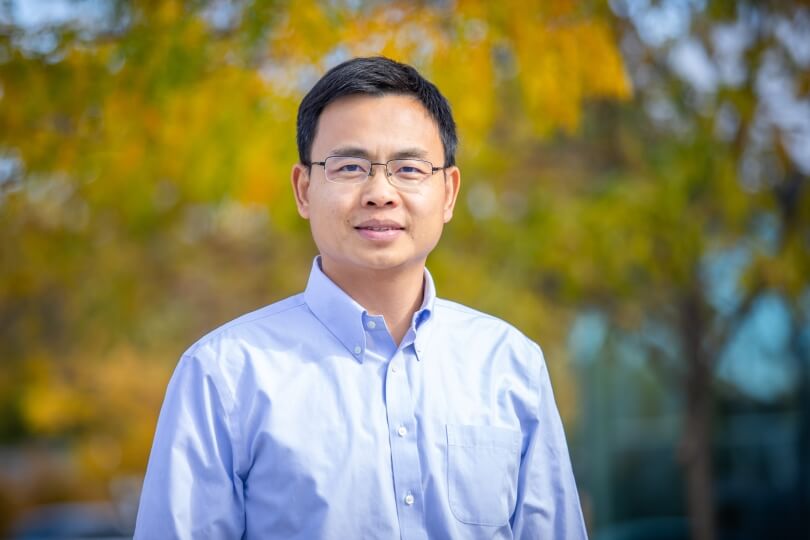 image of person outside smiling in light blue button down shirt 