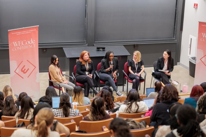 A Harvard SEAS student moderating a panel of four women