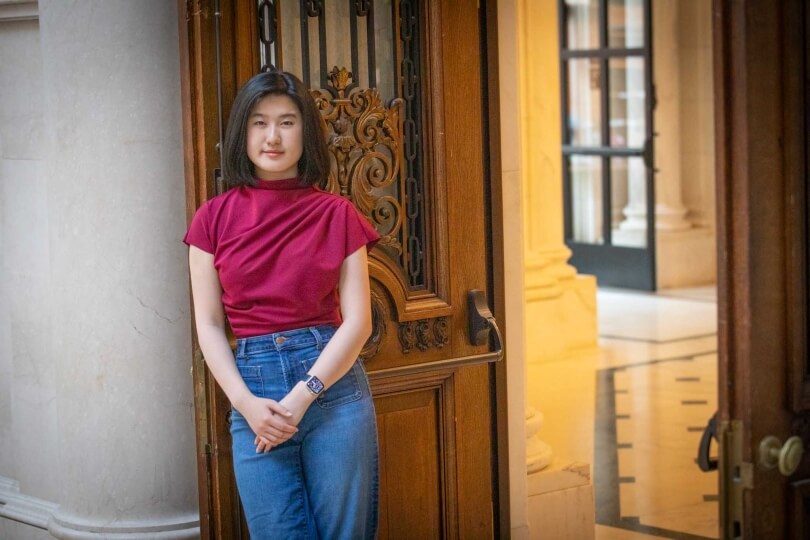 Harvard SEAS student Emma Yang in front of an open door