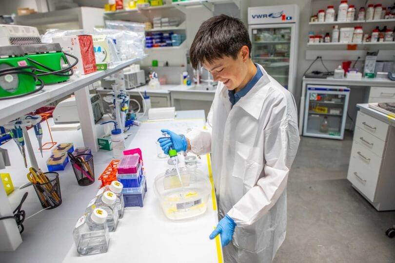 Harvard SEAS student KaiLan Mackey at a lab table with a pipette