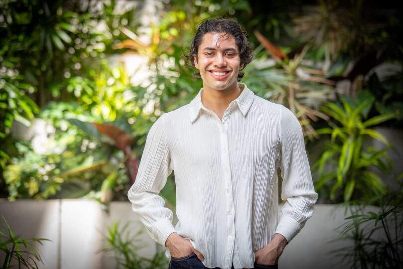 Harvard SEAS student Manav Bansal in front of plants