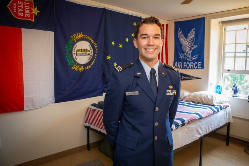 Harvard SEAS student Charles "Trey Whitehead," wearing his Air Force ROTC uniform, in front of the flags of Texas, Kentucky, Alaska, the United States, the U.S. Airforce, and Georgia Institute of Technology