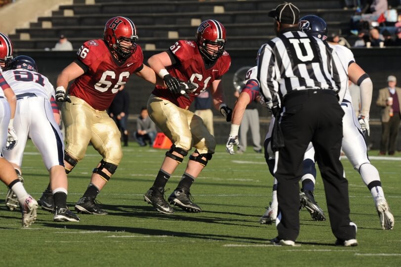 Harvard SEAS alum Michael Mancinelli and Tully co-founder Adam Redmond wearing Crimson football uniforms