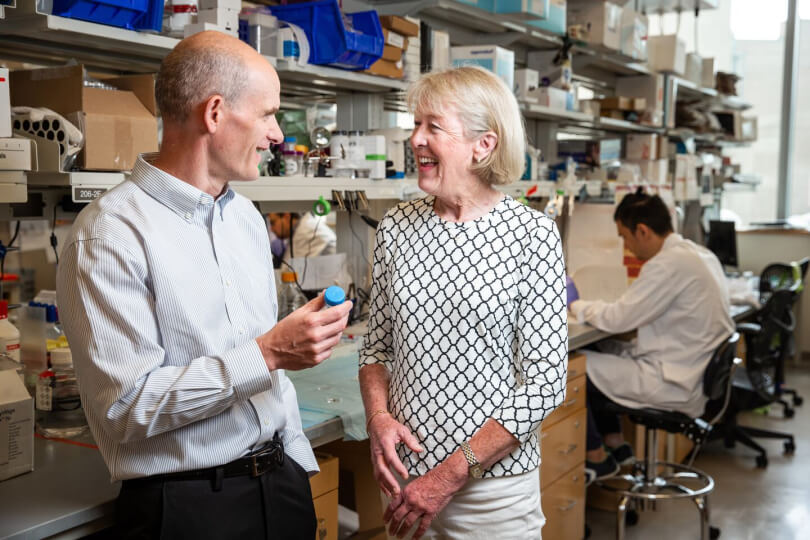 patient speaking with professor in lab