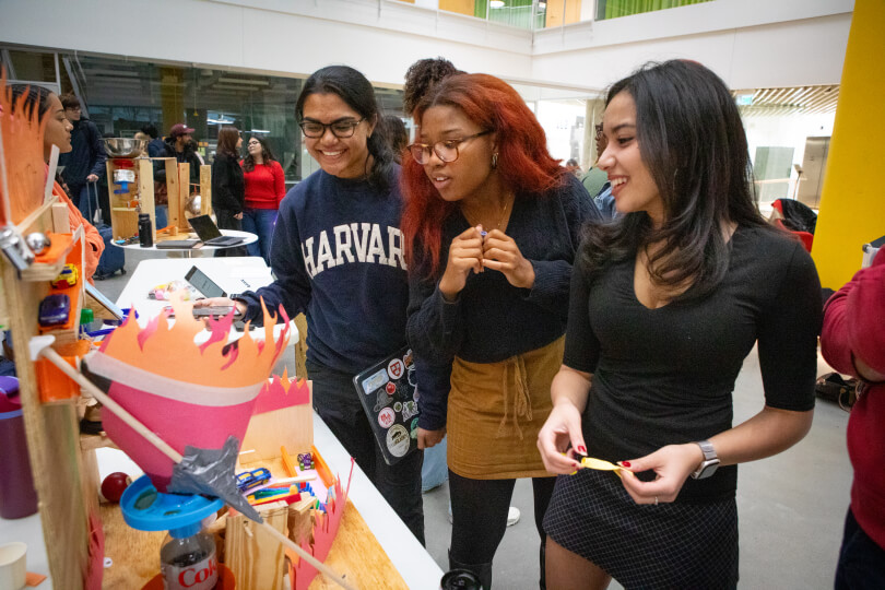 Harvard undergraduate students Mirika Jambudi, Daniela Garcia-Garcia and Keira Adams with their Rube Goldberg Machine