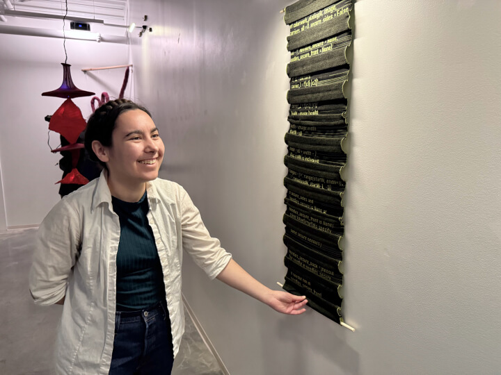 Harvard SEAS student Helen Read with a wall hanging fabric