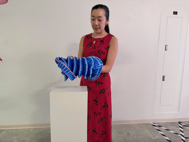 Harvard SEAS student Anya Zhang with an illuminated fabric