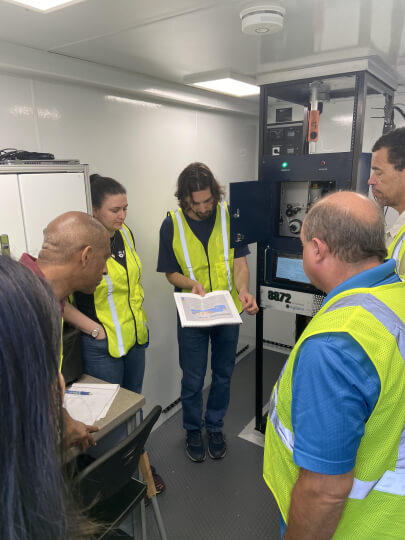 Harvard SEAS alum Nicholas Bobbs, S.B. '16, conducting a training in an Environmental Protection Agency air monitoring trailer