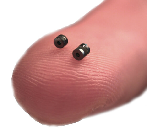 Microcavities of two different lengths, 45 microns and 1 millimeter, placed on a finger tip.