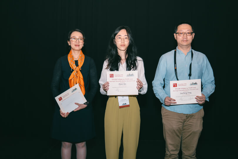 researchers holding award certificates