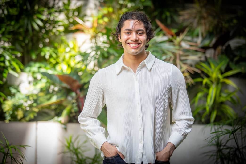 Harvard SEAS student Manav Bansal in front of plants