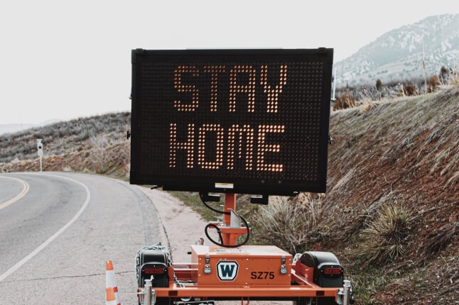 road sign reading stay home