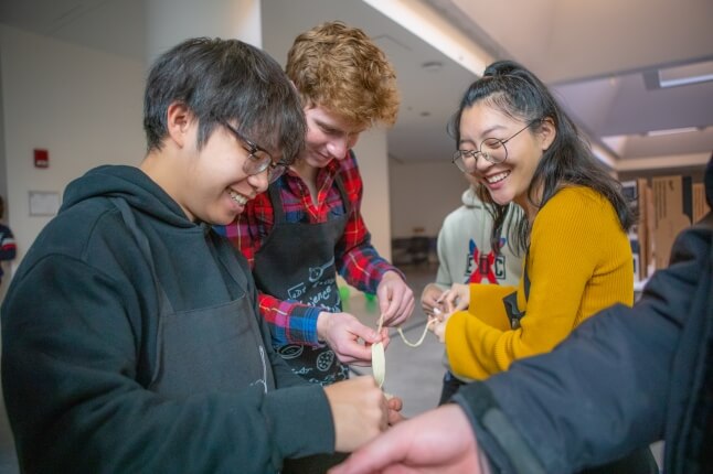 Students team up to create the longest noodle