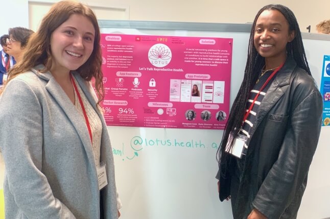 Margaret Cote and Kira Traylor with a poster for the start-up "Lotus"