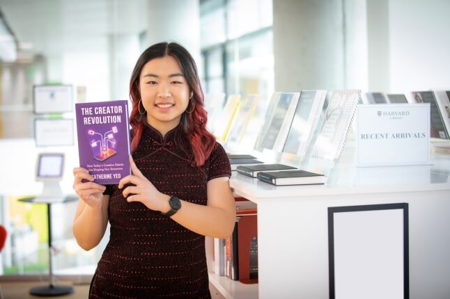 Photo of Catherine Yeo, A.B. '23, with her book, "The Creator Revolution: How Today’s Creative Talents Are Shaping Our Tomorrow"