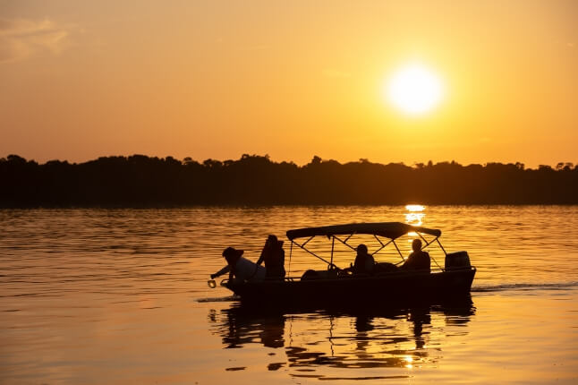 image of researchers on the river at sunset
