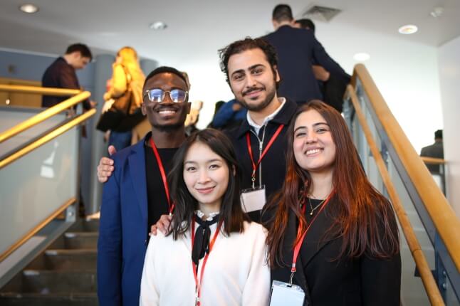 Harvard SEAS MDE students and Enlight co-founders Joachim Asare, Sangyu Xi, Hessan Sedaghat and Prachi Mehta on a stairwell at the MIT Sloan Product Conference in Cambridge